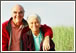 Older couple together standing infront of field